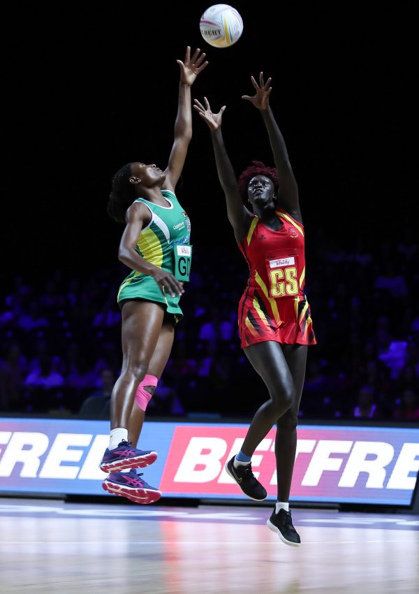 Mary Cholhok (Uganda) fights for the ball against Zimbabwe defence at the 2019 Netball World Cup. Image: May Bailey