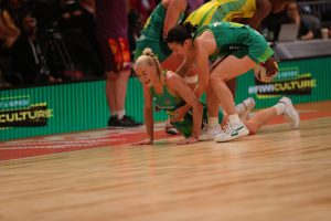 Ash Brazill helps teammate Jo Weston up after one of many tumbles during the semi-final. Image: Danny Dalton | Tah Dah Sports